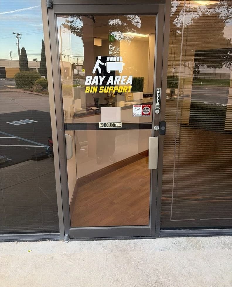 Before and after: an aluminum storefront door with a pull handle and no reader, then the same door with a Kisi reader on the frame.