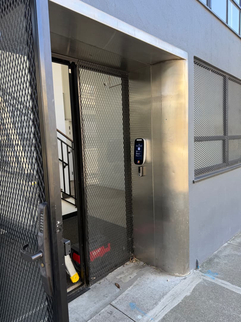 Video intercom installed at a building entry.