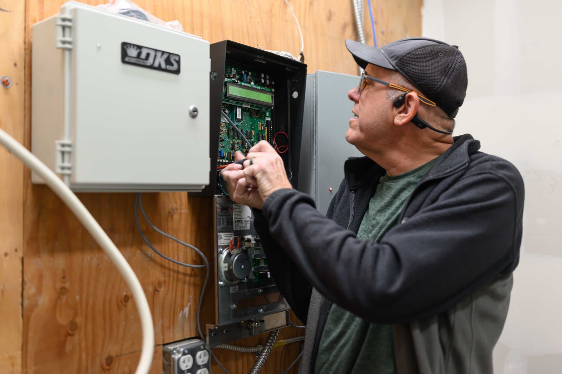 Technician diagnosing a commercial access-control panel at a Bay Area property.