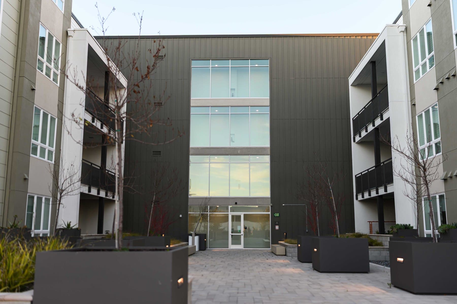 Courtyard exterior of a Bay Area commercial building with multiple tenant entries.
