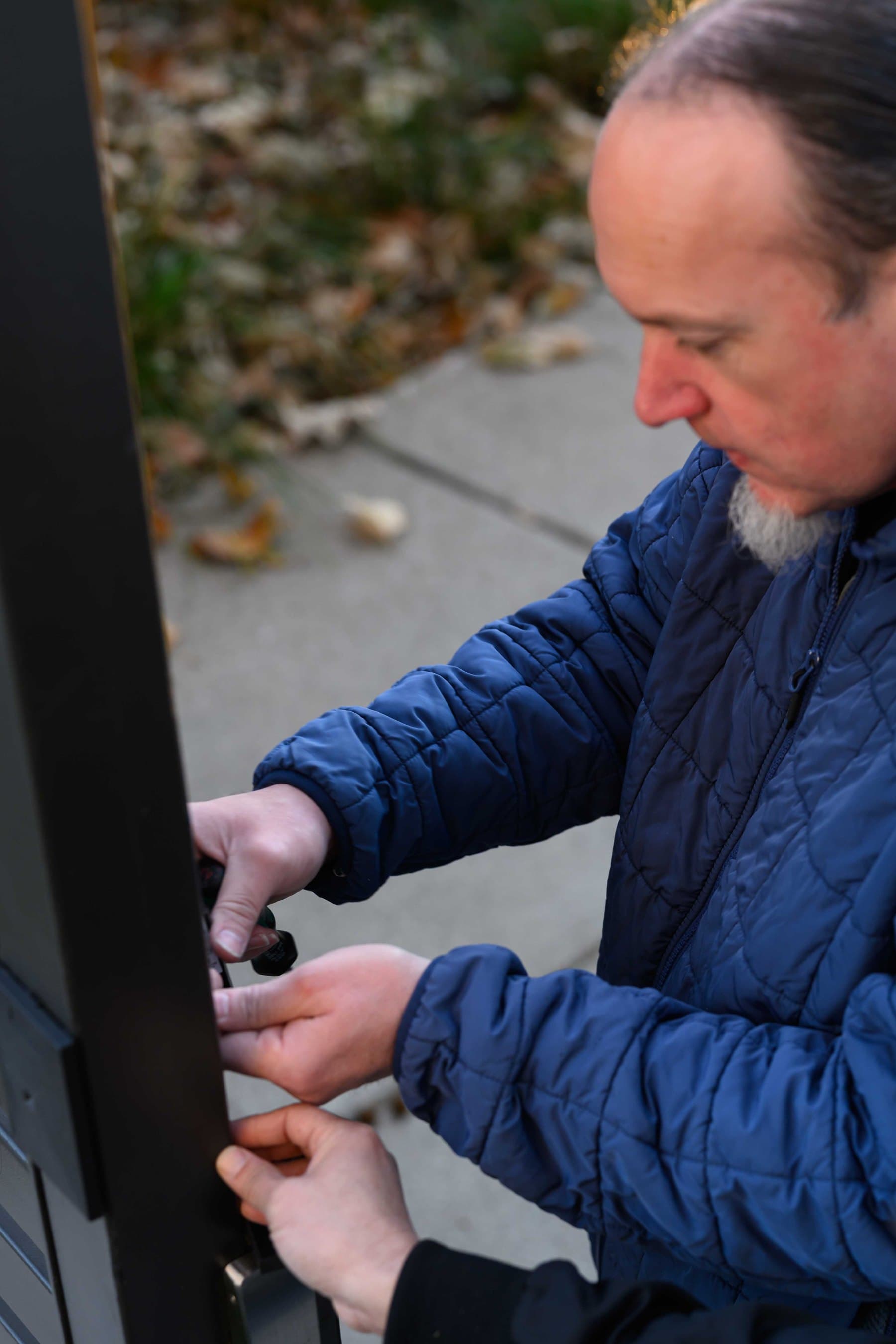 Elwin technician servicing gate hardware at a Bay Area property entry.