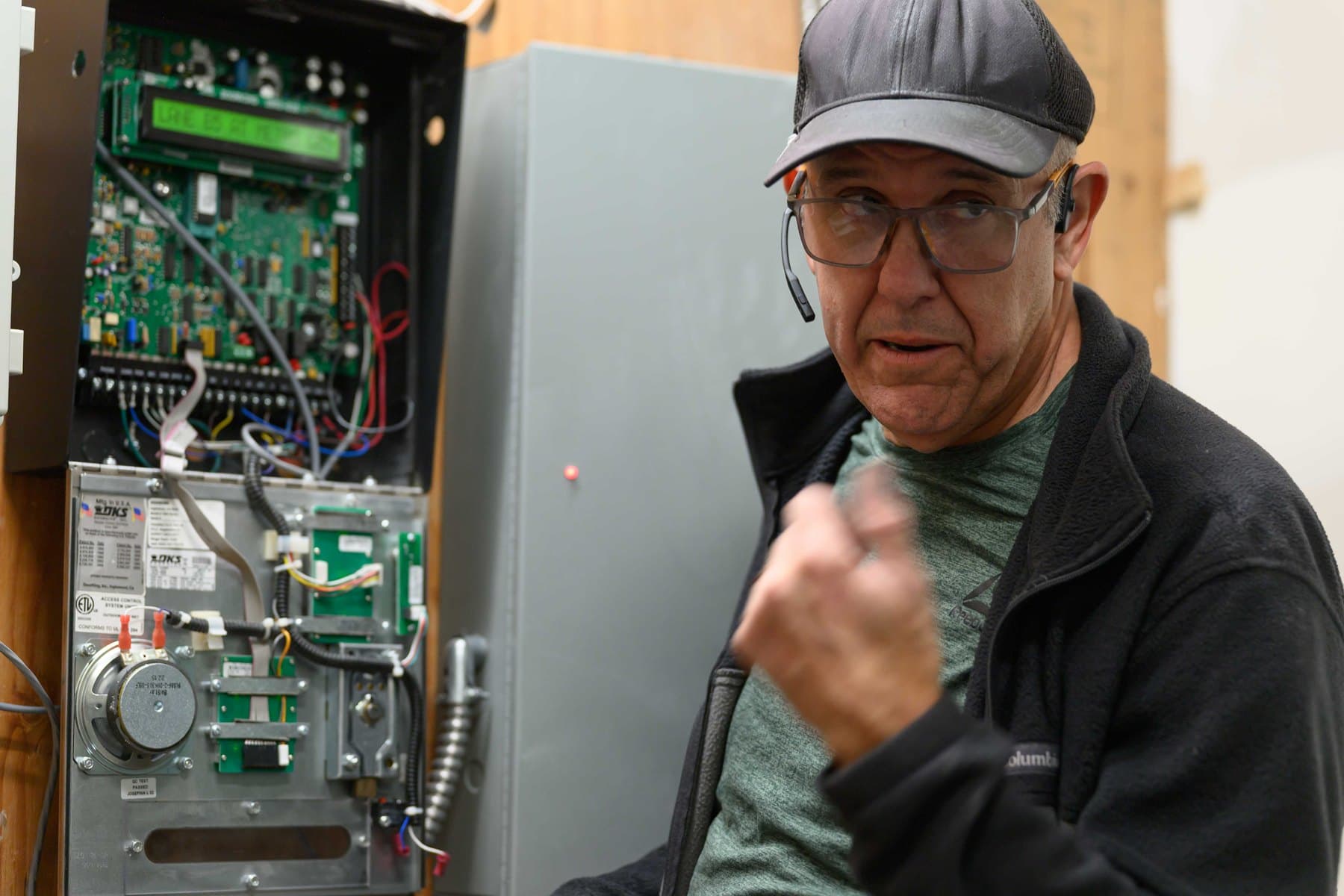 Elwin technician reviewing an access control panel during a property visit
