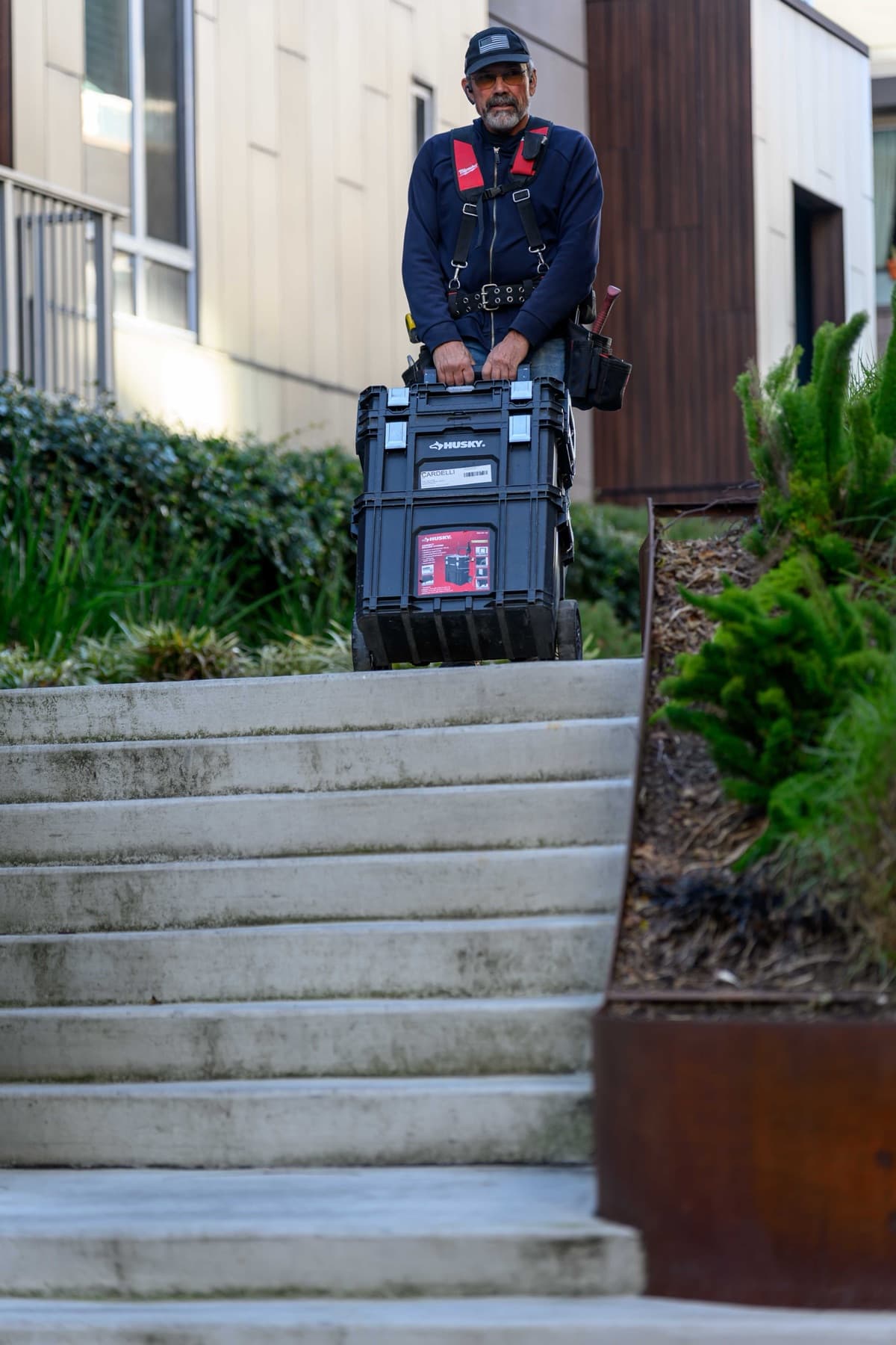 Elwin technician bringing a rolling tool cart to a Bay Area multifamily property.