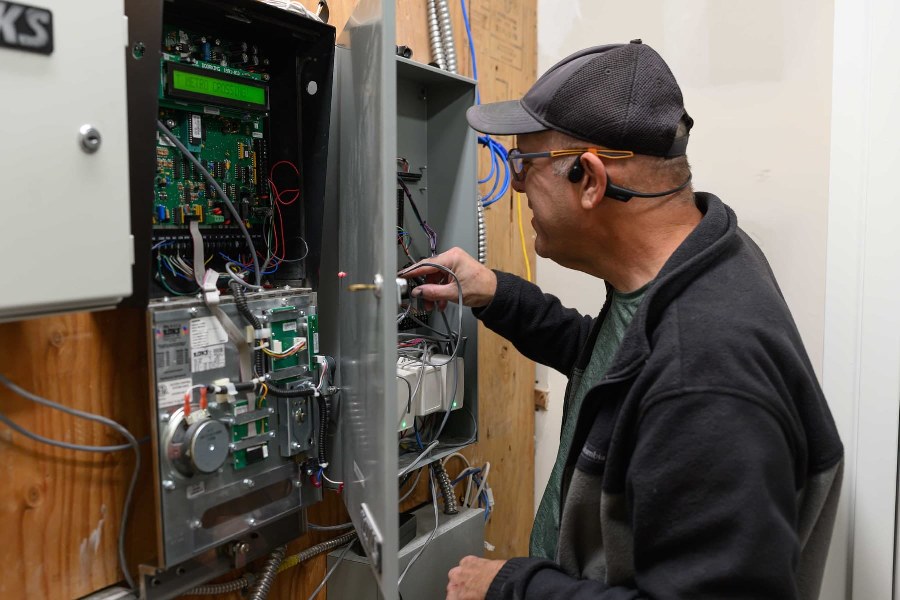 Technician inspecting access control wiring