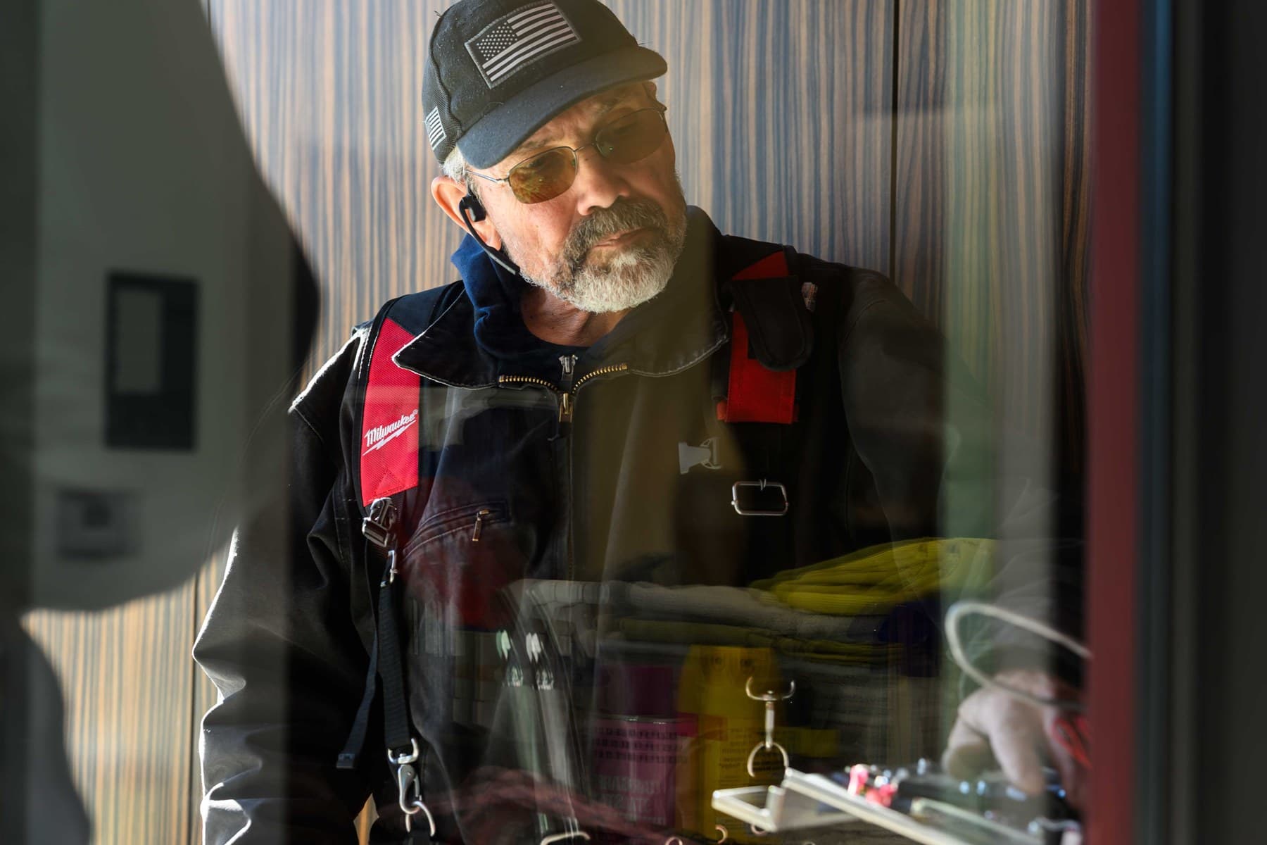 Technician reviewing access hardware during installation
