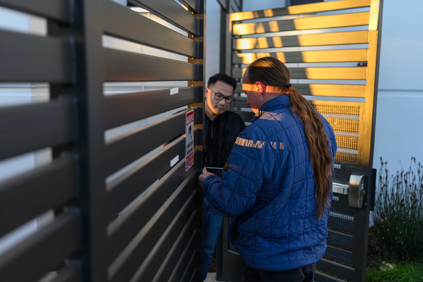 Technician servicing an exterior gate access system