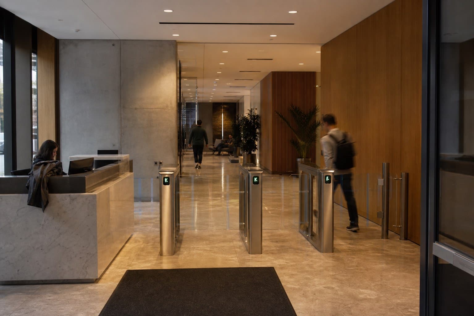 Representative occupied commercial office lobby with reception and controlled turnstiles