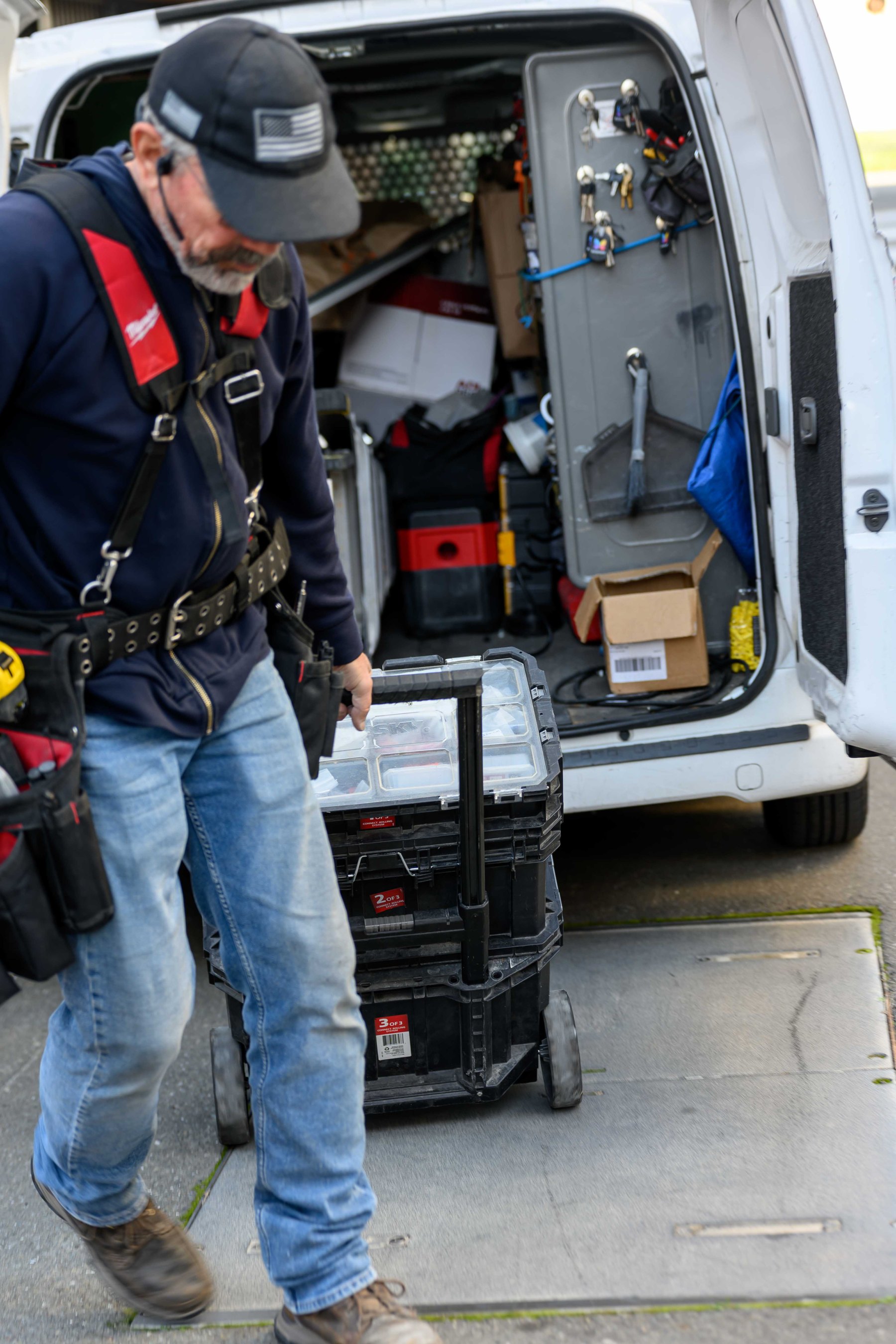 Technician organizing tools at an Elwin service van.